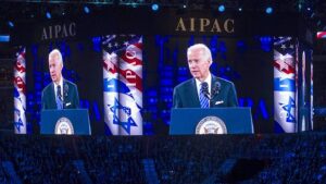 Biden is seen on large video screens as he addresses the American Israel Public Affairs Committee policy conference in Washington, DC, in 2016 [Cliff Owen/AP]